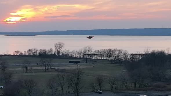 An aerial view over Calvert Vaux Park in Brooklyn, NY during a cloudy evening. The drone camera pan