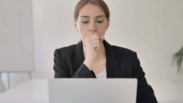 Close Up of Sick Young Businesswoman Coughing at Work