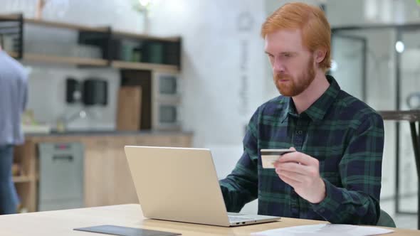 Successful Online Payment on Laptop By Beard Redhead Man