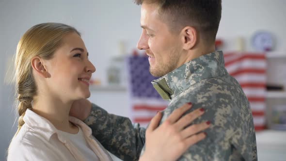 Joyful Wife Hugging Military Husband and Smiling at Camera, Homecoming After War