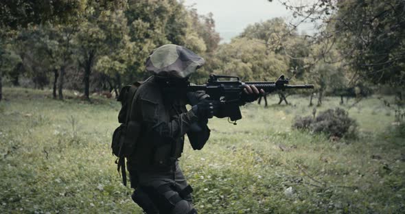 Squad of fully armed commando soldiers during combat in a forest scenery