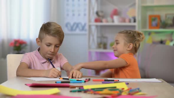 Young Sister Disturbing Elder Brother Drawing Table, Family Communication, Fun