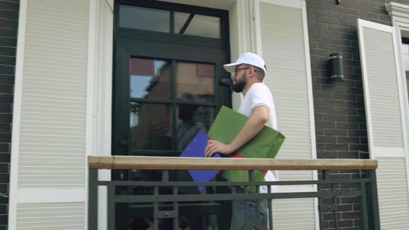 Woman Taking Parcel and Signing Folder.