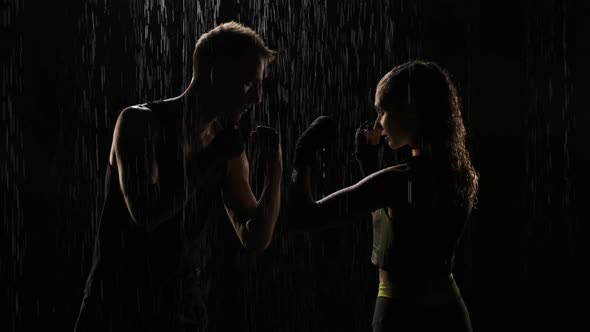 Guy and Girl Stand in Fight Stand in the Rain. Woman and Man Are Ready for Fight and Stand Opposite