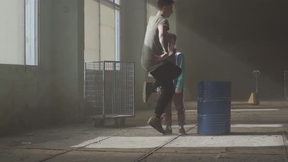 Dance Battle of Two Street Dancers in an Abandoned Building Near the Barrel