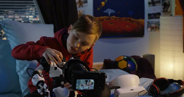 Boy Filming Review of Toy Robot
