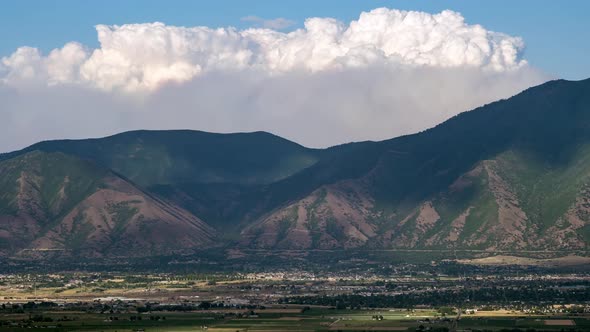 Time lapse of smoke from wild fire burning over mountains