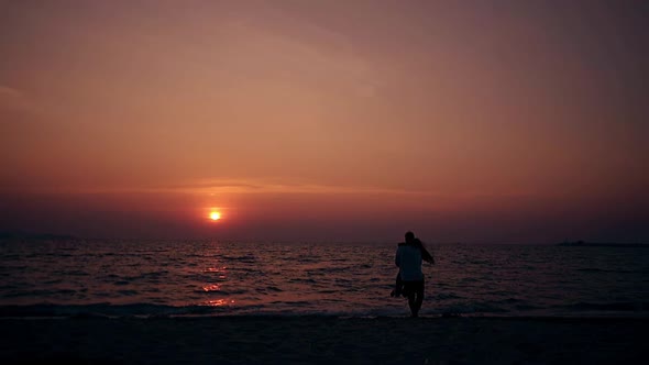 Couple Hugs and Kisses on Empty Evening Beach Slow Motion