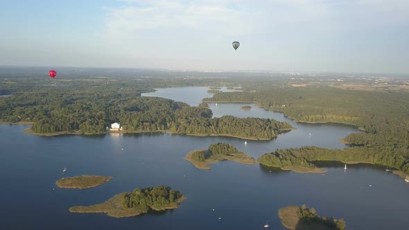 Hot Air Balloons Flying Over Beautiful Lakes and Islands in Lithuania Near the Trakai Castle in