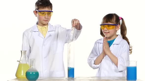 Two Cute Chemist Children Making Interesting and Successful Experiments with Blue Foam Isolated on