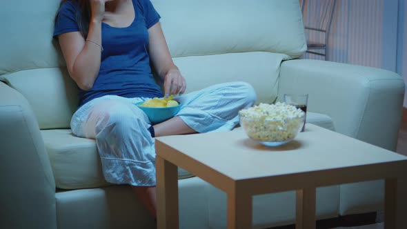 Speaking on Phone Holding Snacks Bowl