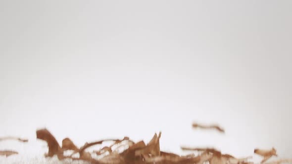 Crispy Apple Chips Jump and Fall on Isolated White Background