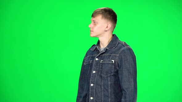 Young Man Walking and Greeting on a Green Screen, Chroma Key. Slow Motion