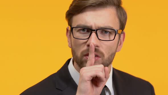 Man Holding Finger Near His Lips Showing Silence Sign, Top Secret Investigation