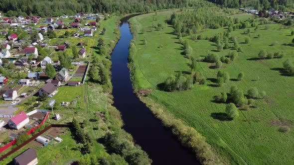 Aerial Flying Over the River and the Village