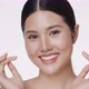 Close up portrait smiling young Asian girl massaging her beautiful face. - VideoHive Item for Sale