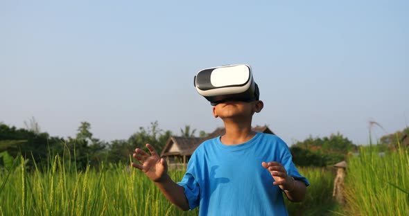 Rural Boy Explores Virtual Reality at Rice Field