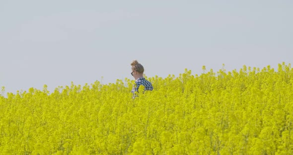 Farmer Examining Oil Seed Canola Field