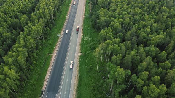 Aerial View of Cars and Trucks Driving Fast Along a Suburban Highway