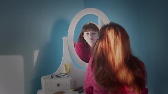 Woman Looks in the Mirror and Admires Herself, Moving Camera