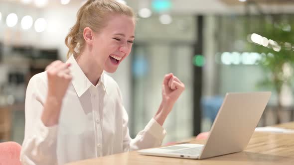 Beautiful Businesswoman Celebrating Success on Laptop