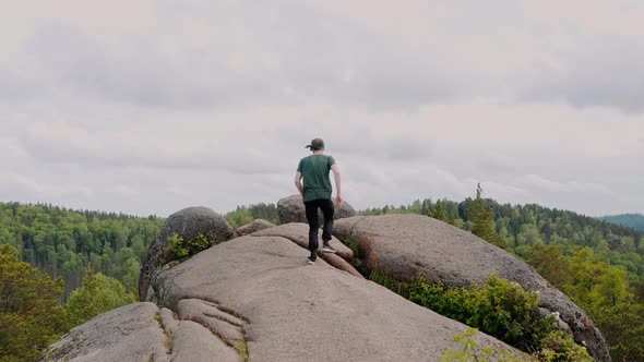 The tourist on the mount The man on the top of the mount The Krasnoyarsk Pillars