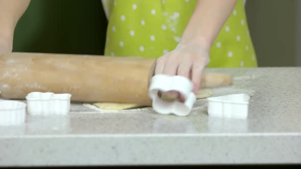 Hands of Child Rolling Dough.