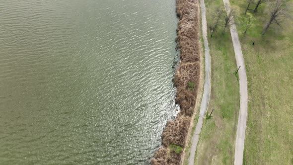 An aerial view over Flushing Meadow Corona Park in Queens, NY on a sunny day. The drone camera dolly