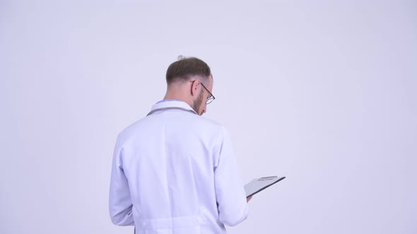 Rear View of Bearded Man Doctor Directing While Pointing Finger