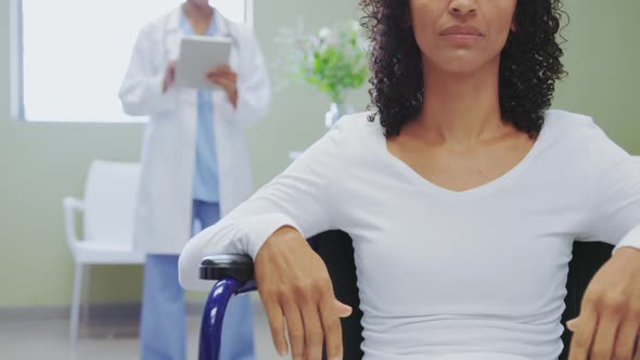 Close-up of African american disabled female patient sitting on wheelchair in the ward at hospital