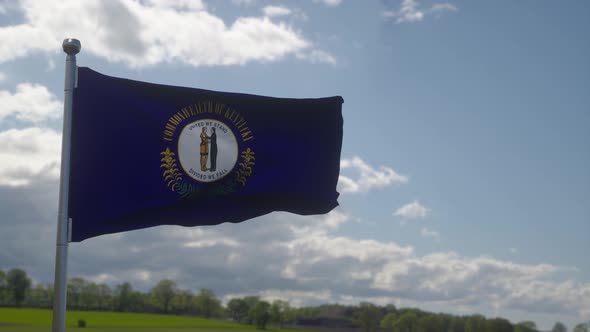 Kentucky Flag on a Flagpole Waving in the Wind in the Sky