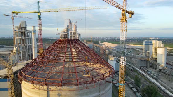 Aerial View of Cement Factory Under Construction with High Concrete Plant Structure and Tower Cranes