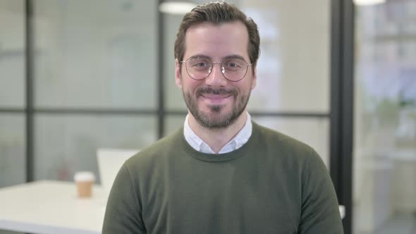 Portrait of Attractive Young Businessman Smiling at Camera