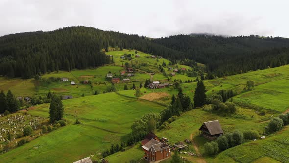 Mountain Village with a Cemetery in the Summer Season