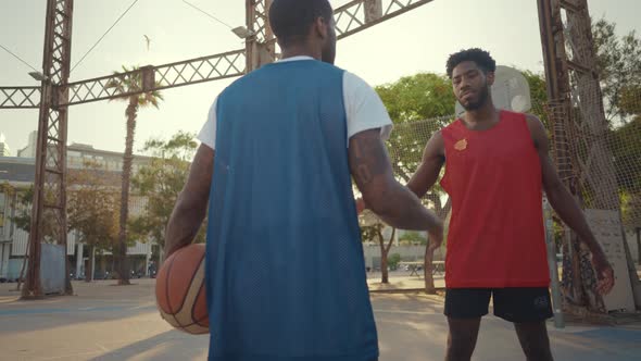 Cinematic footage of a street basketball game outdoor.