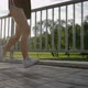 SLOW MOTION CLOSE UP Female Running in Green Park in Small Suburban Town with Tall Buildings in the - VideoHive Item for Sale