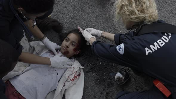 Medical Specialists Rescuing Little Patient on Road