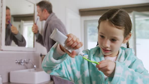 Happy girl pasting toothpaste on toothbrush 4k