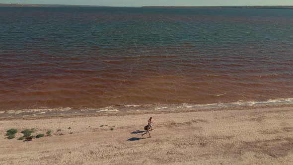 Two People Running By Sand Beach Coastline Sand Bar at Mykolaiv Region Ukraine