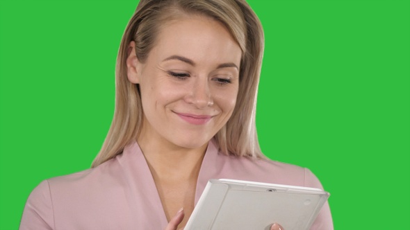 Active business woman holding tablet on a Green Screen, Chroma Key.