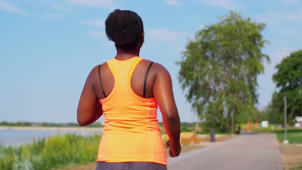 Young African American Woman Running at Seaside