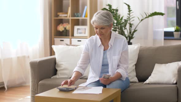 Senior Woman with Money and Bills at Home 3