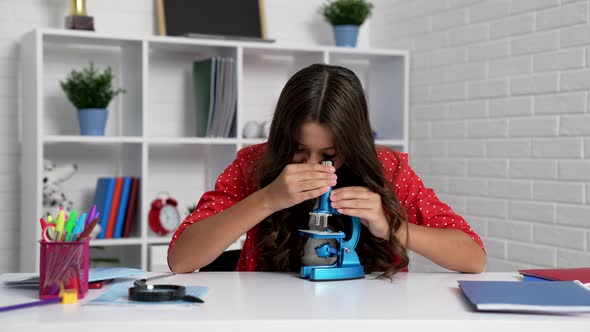 Amazed Teen Girl Researching with Microscope Chemistry