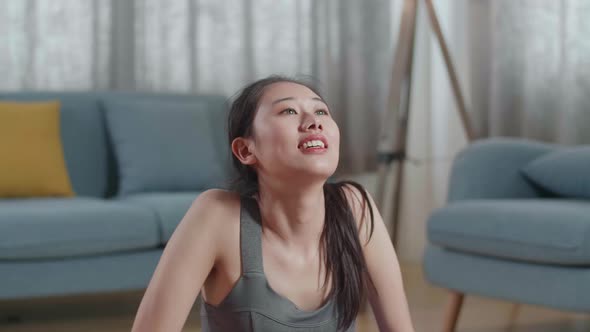 Asian Female In Sports Clothes Training On A Yoga Mat, Doing Upward Facing Dog During Workout