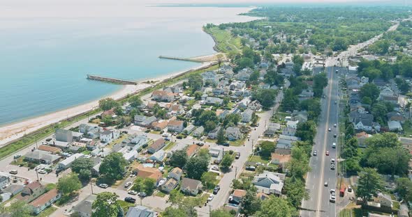 Sunny day aerial view of beautiful small town residential area from a height against the bay NJ USA