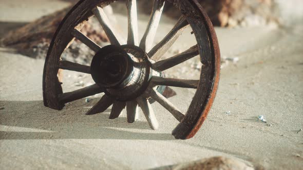 Large Wooden Wheel in the Sand