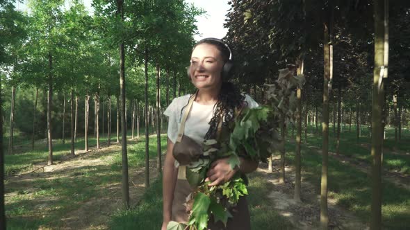 Woman Worker Walks Through the Garden