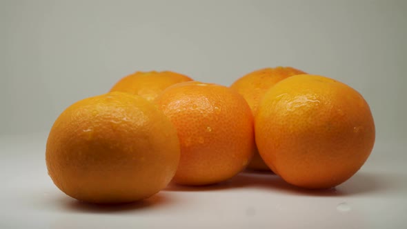 Five Sweet Oranges At The Top Of The Table With White Background - Close Up Shot