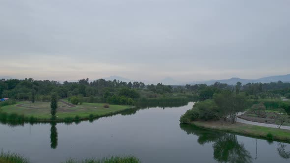 Jib up above lake and natural area in Mexico City