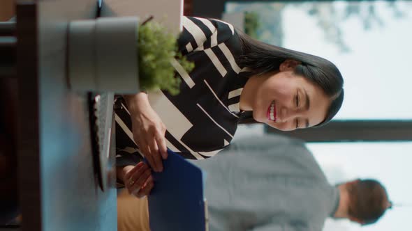 Vertical Video Asian Worker Greeting Female Applicant at Job Interview